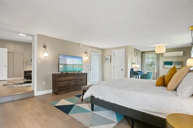 a bedroom with a large bed and a window