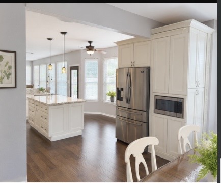 13 Oak View Round Rock, TX 78664 - Photo 12 of 30 An inviting open-concept kitchen features a spacious island and gleaming hardwood floors.