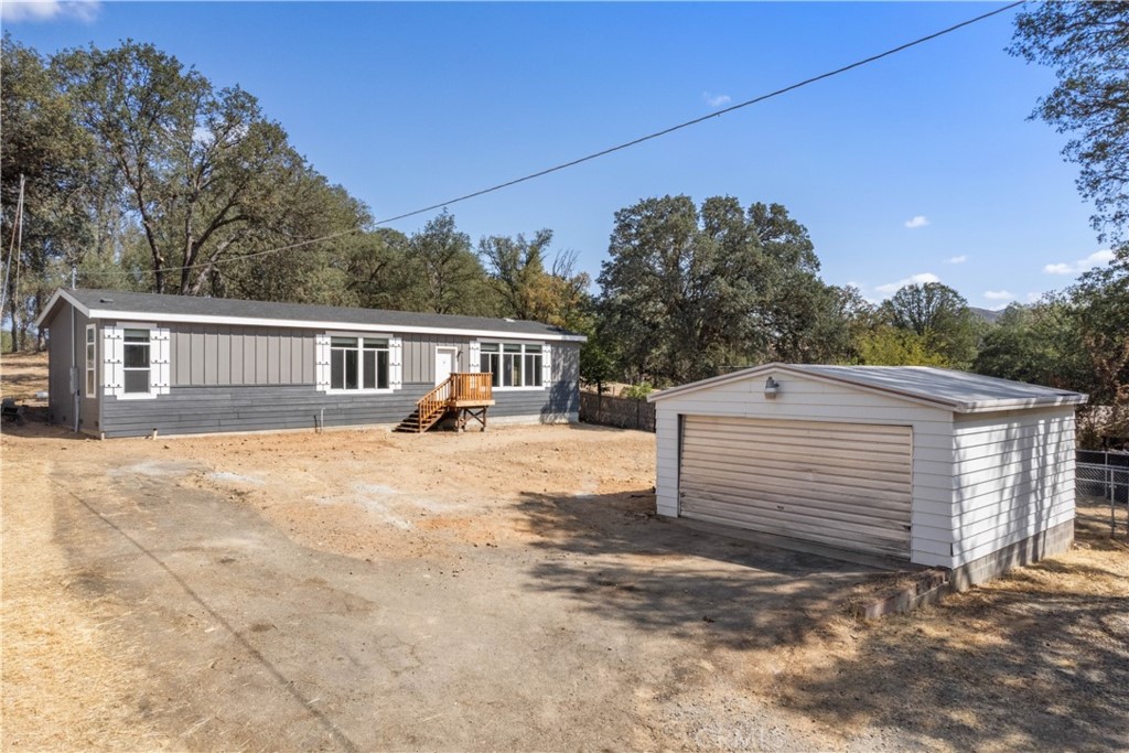 16844 Pebble Court Lower Lake, CA 95457 - Photo 1 of 51 a view of a house with a backyard and a garage