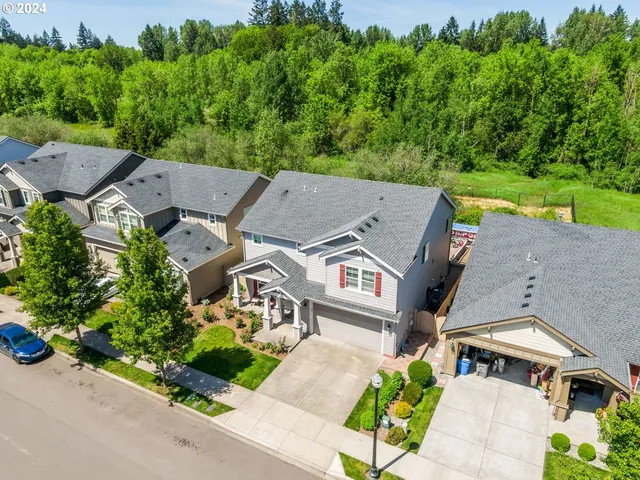 an aerial view of a house with a garden and trees