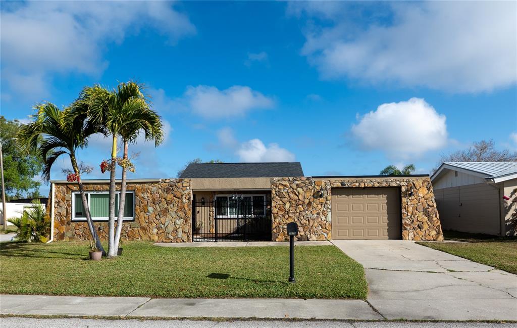 3629 Haven Drive New Port Richey, FL 34652 - Photo 1 of 20 a front view of a house with a yard and garage