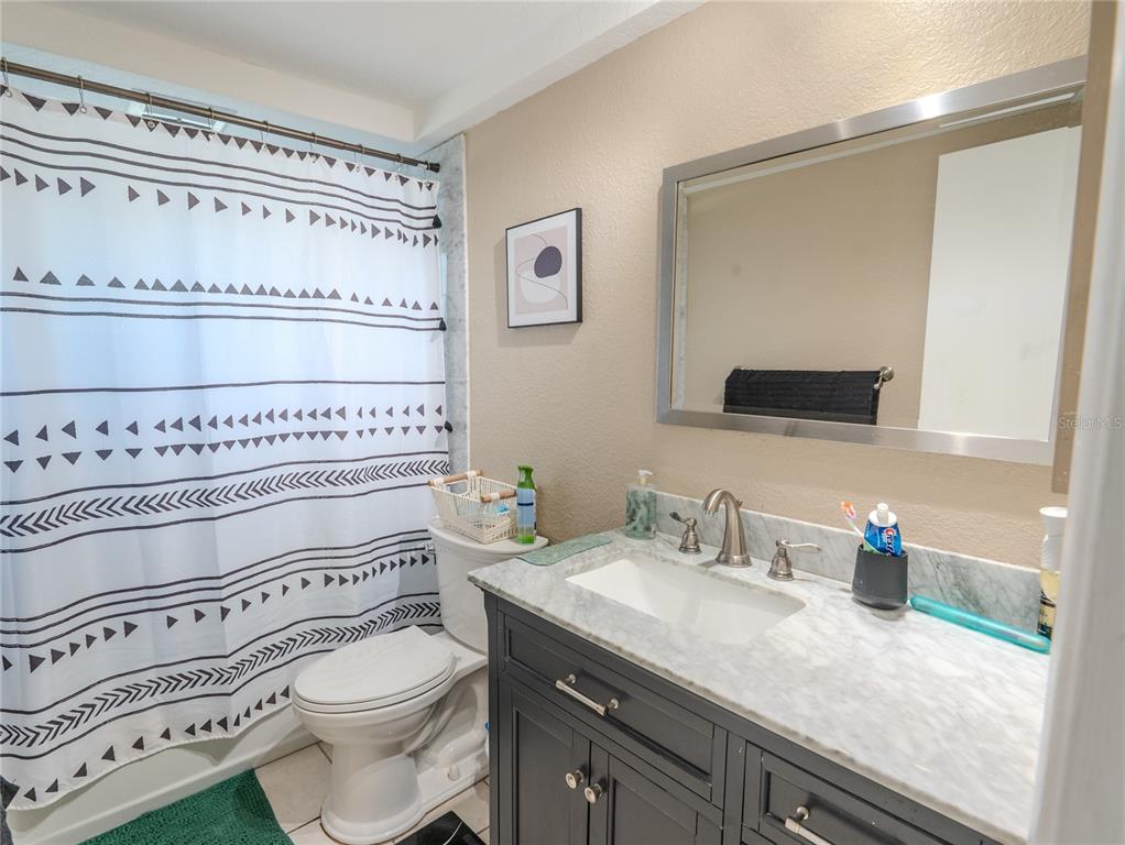3629 Haven Drive New Port Richey, FL 34652 - Photo 11 of 20 a bathroom with a granite countertop toilet sink and mirror