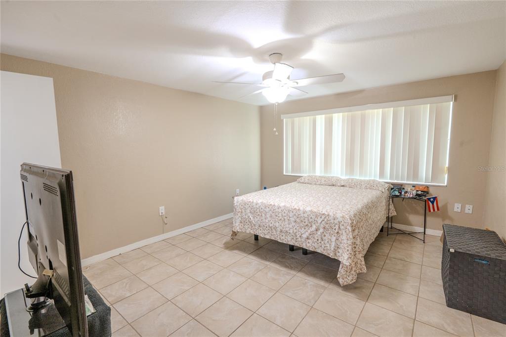 3629 Haven Drive New Port Richey, FL 34652 - Photo 12 of 20 a spacious bedroom with a bed and a flat screen tv