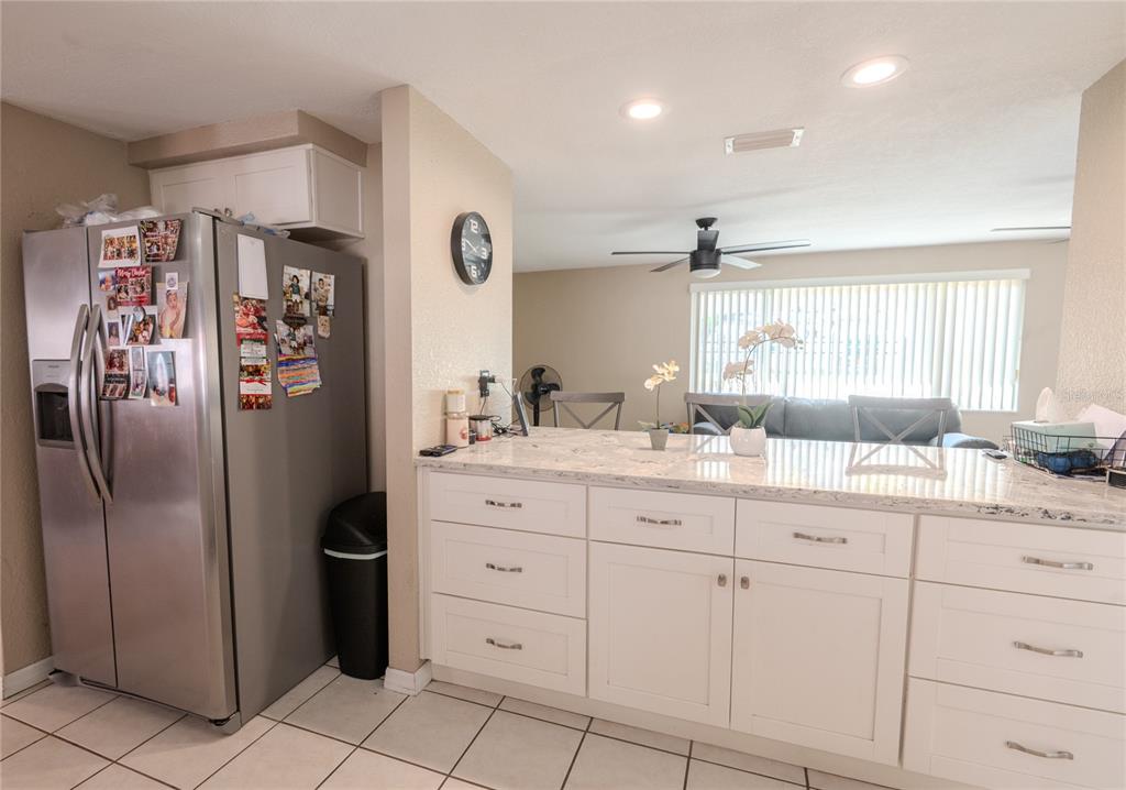3629 Haven Drive New Port Richey, FL 34652 - Photo 14 of 20 a bathroom with a granite countertop sink a mirror a toilet and a shower