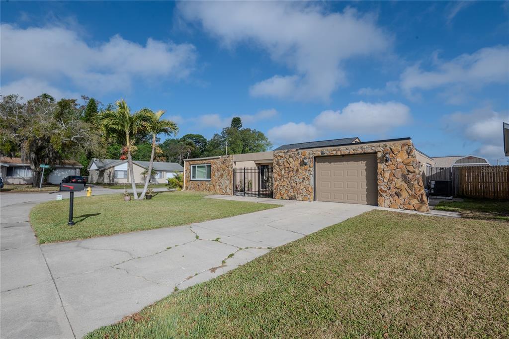 3629 Haven Drive New Port Richey, FL 34652 - Photo 2 of 20 a front view of a house with a yard and garage