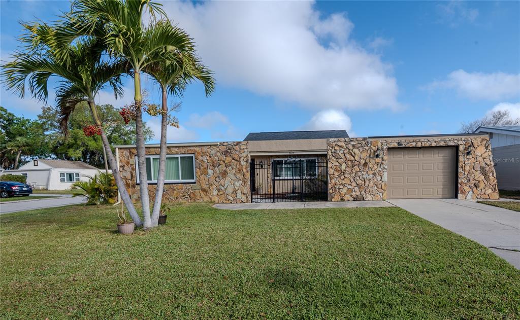 3629 Haven Drive New Port Richey, FL 34652 - Photo 4 of 20 a view of a house with a yard and garage