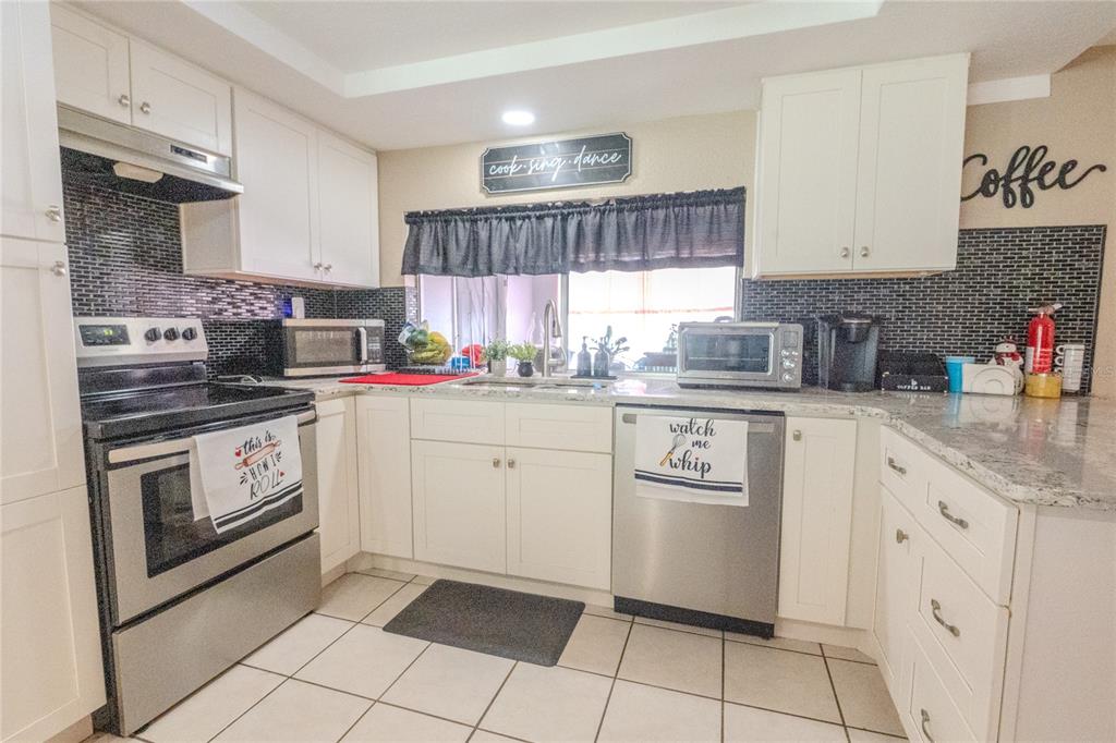 3629 Haven Drive New Port Richey, FL 34652 - Photo 8 of 20 a kitchen with cabinets appliances a sink and a counter top space