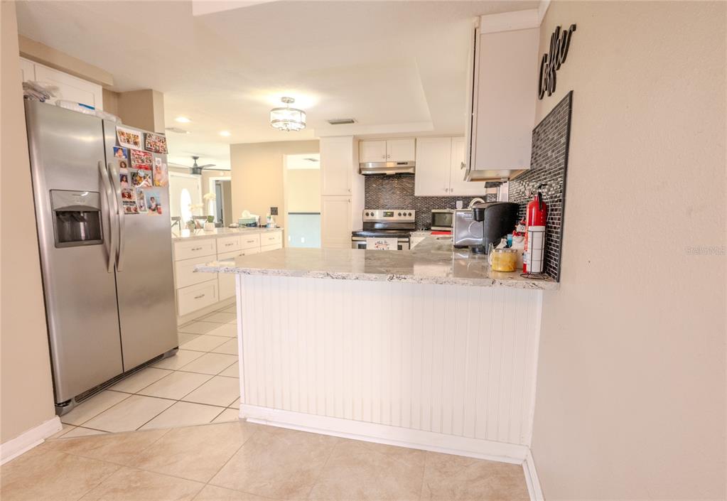 3629 Haven Drive New Port Richey, FL 34652 - Photo 9 of 20 a kitchen with refrigerator and cabinets