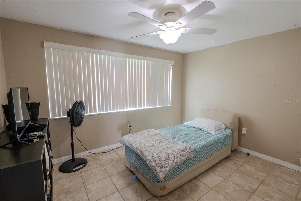 3629 Haven Drive New Port Richey, FL 34652 - Photo 10 of 20 a bedroom with a bed and a chandelier