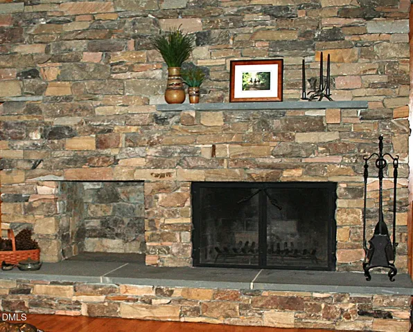 a bedroom with a bed and a lamp on dresser