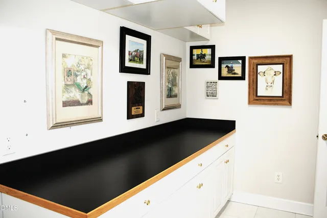 a kitchen with a sink a window and cabinets