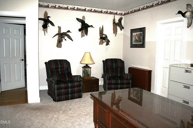 a bedroom with a bed and painting on the wall