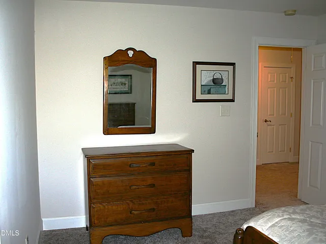 a view of a patio with lawn chairs under an umbrella
