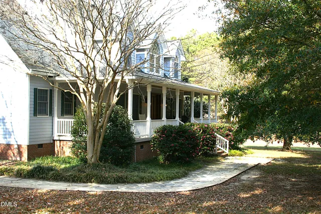 a kitchen with granite countertop a table and chairs in it