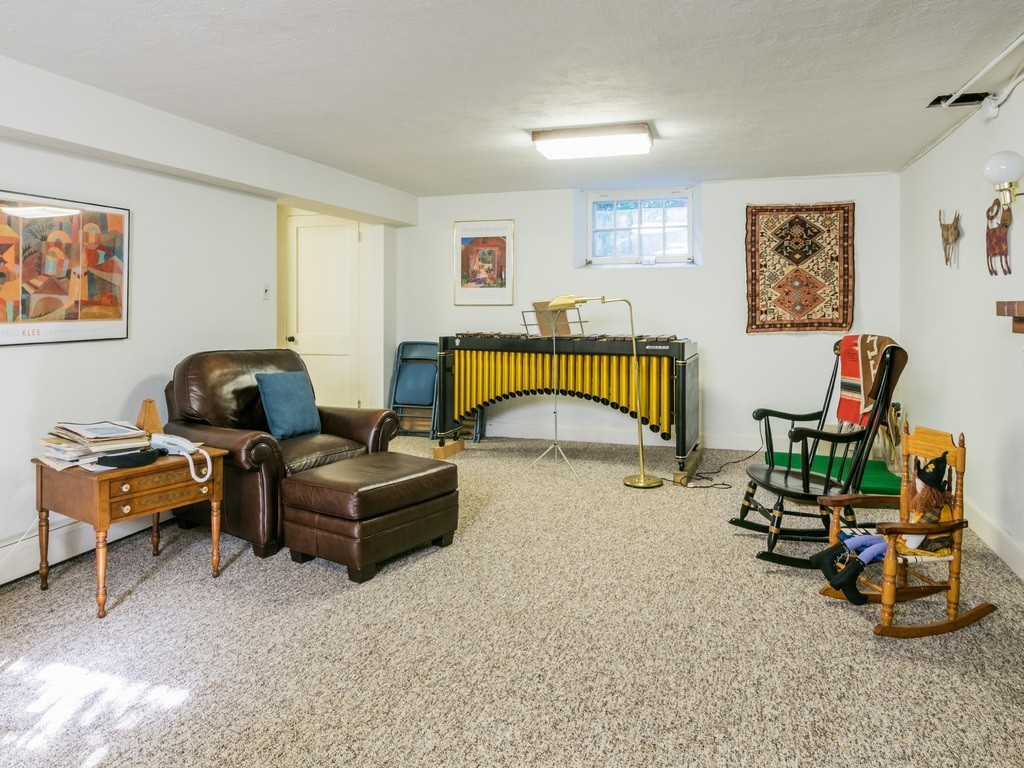 80 Dean Road Weston, MA 02493 - Photo 25 of 28 a living room with furniture gym equipment and a window