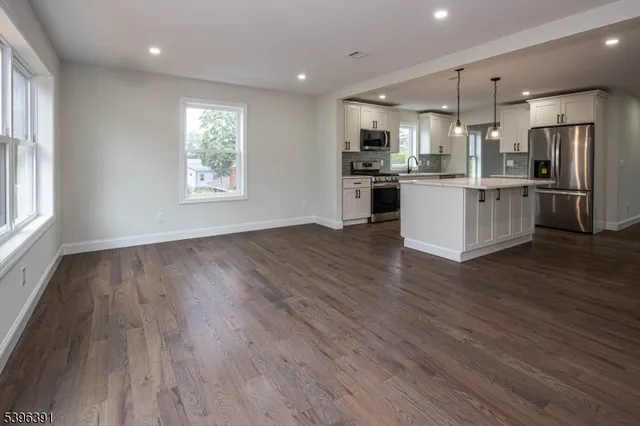 a view of kitchen with wooden floor and window