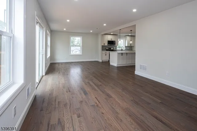 a view of kitchen with wooden floor and electronic appliances