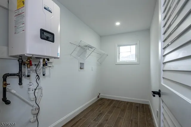 a view of a room with wooden floor and windows