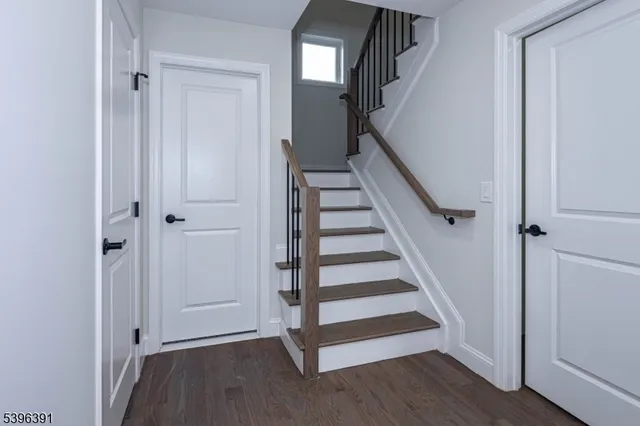 a view of entryway with wooden floor and stairs