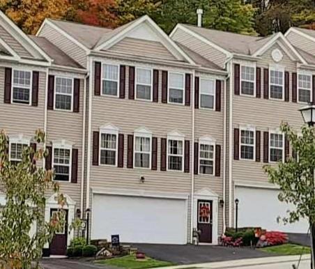 a front view of a residential houses with yard