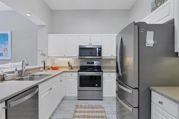 a kitchen with stainless steel appliances granite countertop a refrigerator stove and sink