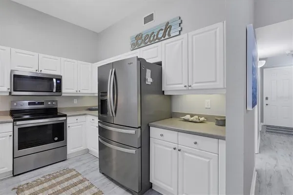 a kitchen with stainless steel appliances granite countertop a refrigerator stove and sink