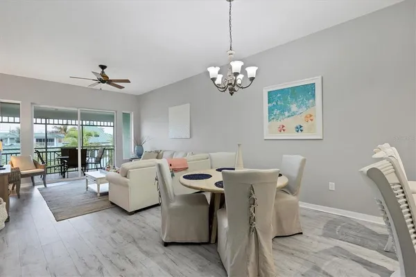 a view of a dining room with furniture wooden floor and chandelier