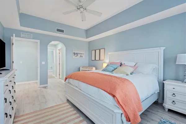 a bedroom with a bed and a chandelier