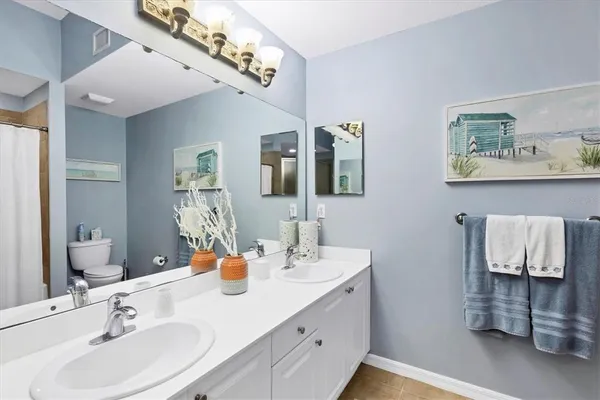 a bathroom with a double vanity sink and a mirror