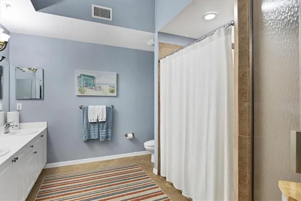 a spacious bathroom with a double vanity sink and a mirror