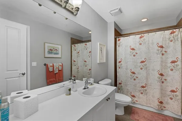 a bathroom with a sink toilet and shower