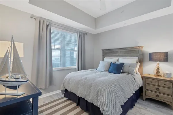 a bedroom with a bed and a potted plant