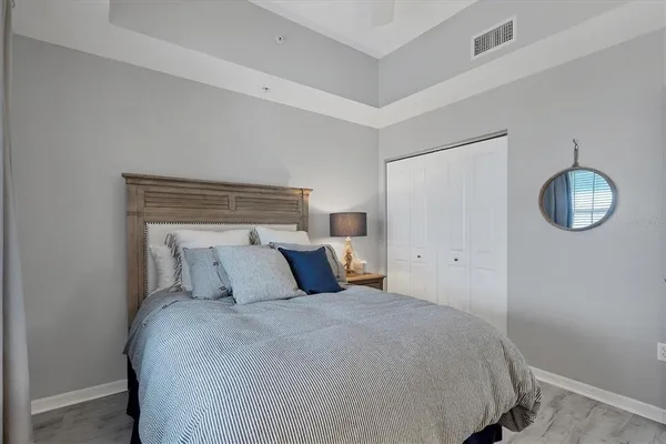 a bedroom with a bed and a chandelier