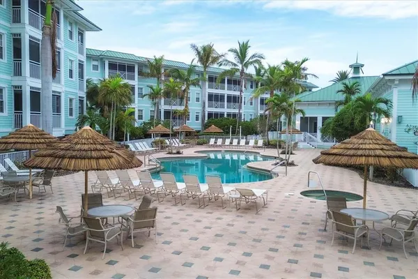 a swimming pool with outdoor seating and plants