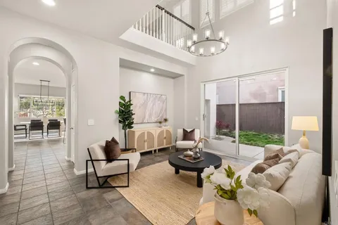 a living room with furniture a mirror and a fireplace