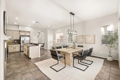 a kitchen with kitchen island a stove a sink and a refrigerator