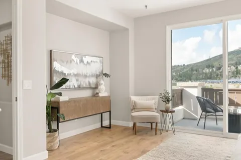 a backyard of a house with fountain table and chairs