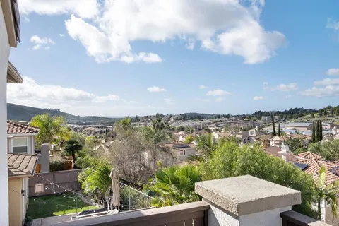 a kitchen with a stove and a wooden floor