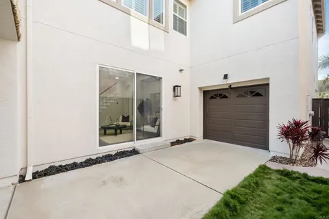 an aerial view of residential houses with outdoor space and trees