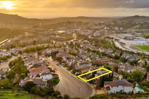 a view of mountain with sunset in background
