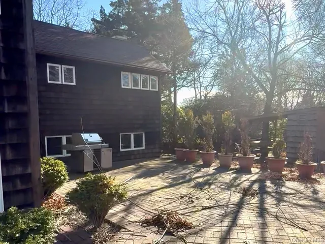 a backyard of a house with yard and outdoor seating