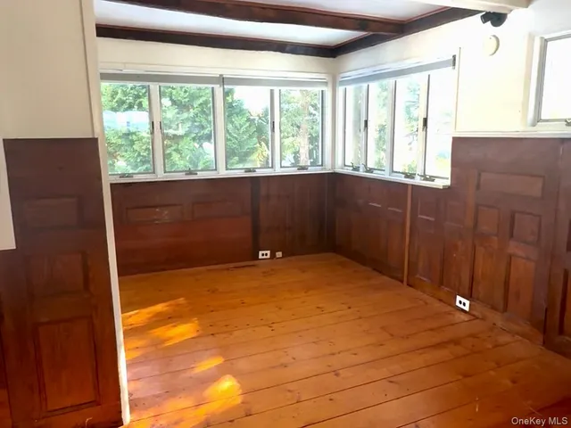 a large kitchen with granite countertop a large window a sink and stainless steel appliances