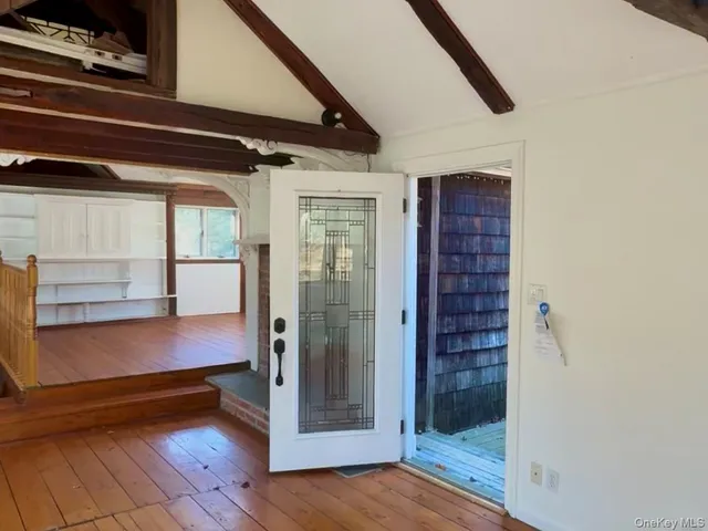 a bathroom with a granite countertop sink mirror vanity and a bathtub