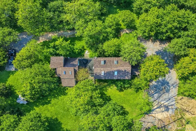 a view of a big yard with large trees and a small yard