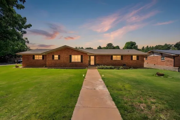 a front view of house with yard and green space