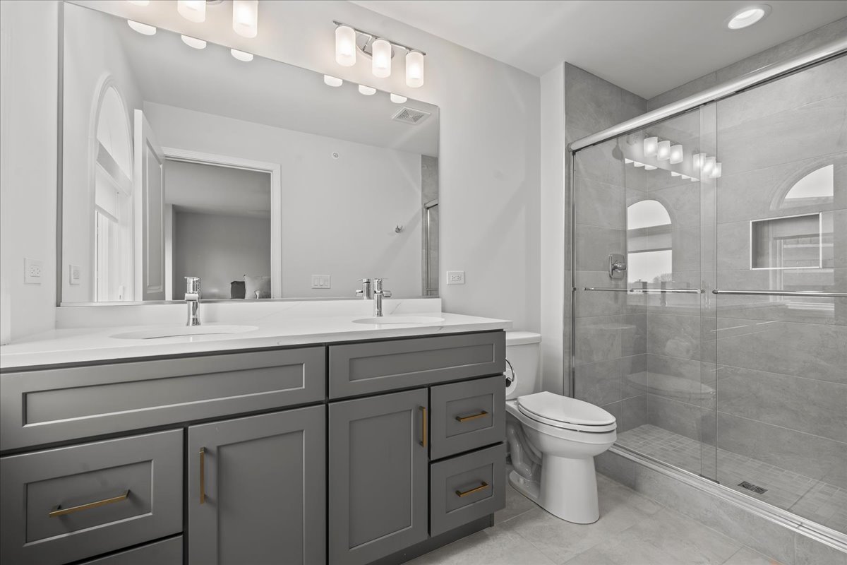 1229 Shermer Road Northbrook, IL 60062 - Photo 8 of 22 a bathroom with a sink a toilet and shower