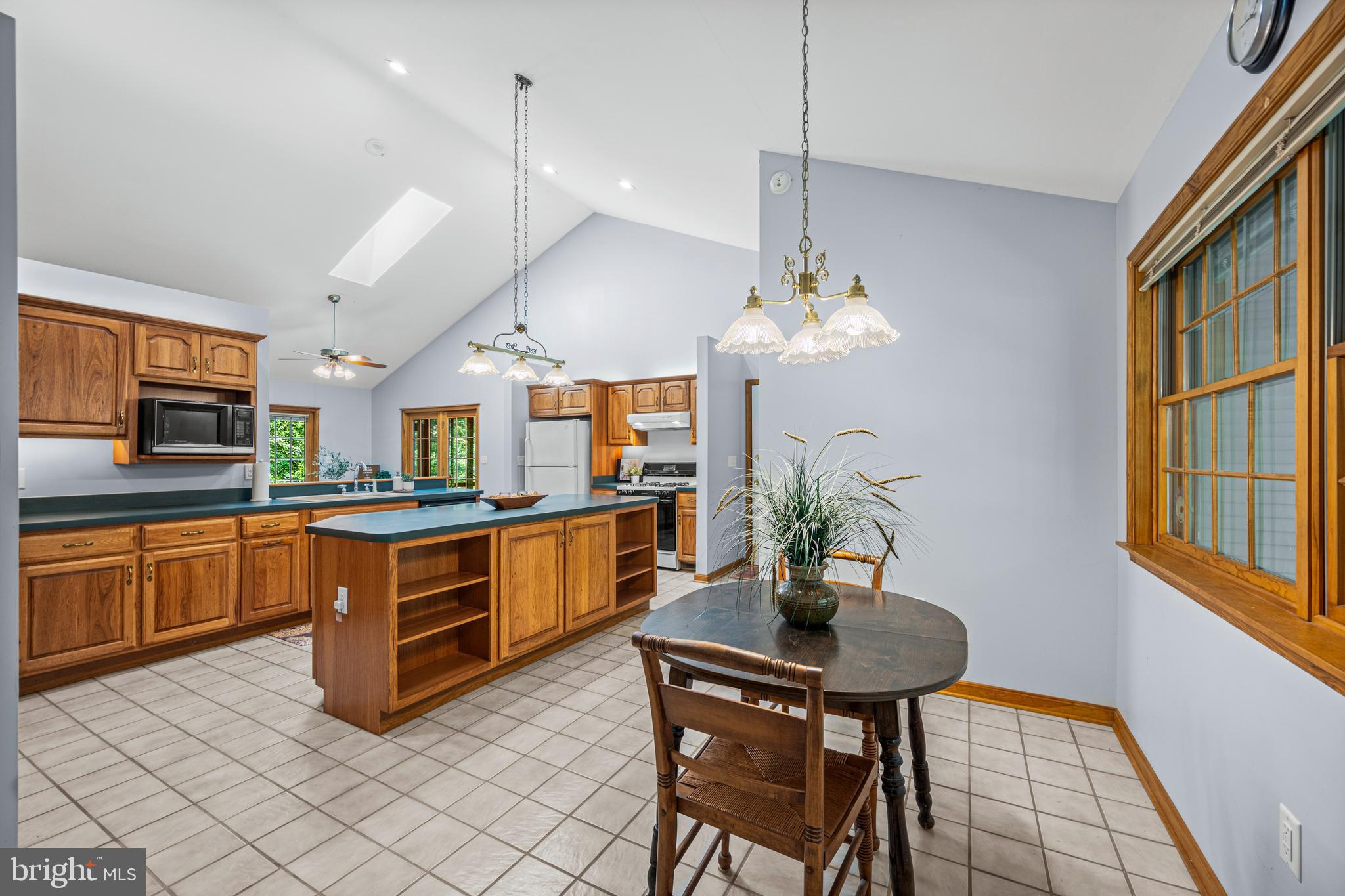1160 Mt Hope Road Fairfield, PA 17320 - Photo 19 of 34 a kitchen with stainless steel appliances granite countertop a stove a sink dishwasher a dining table and chairs with wooden floor