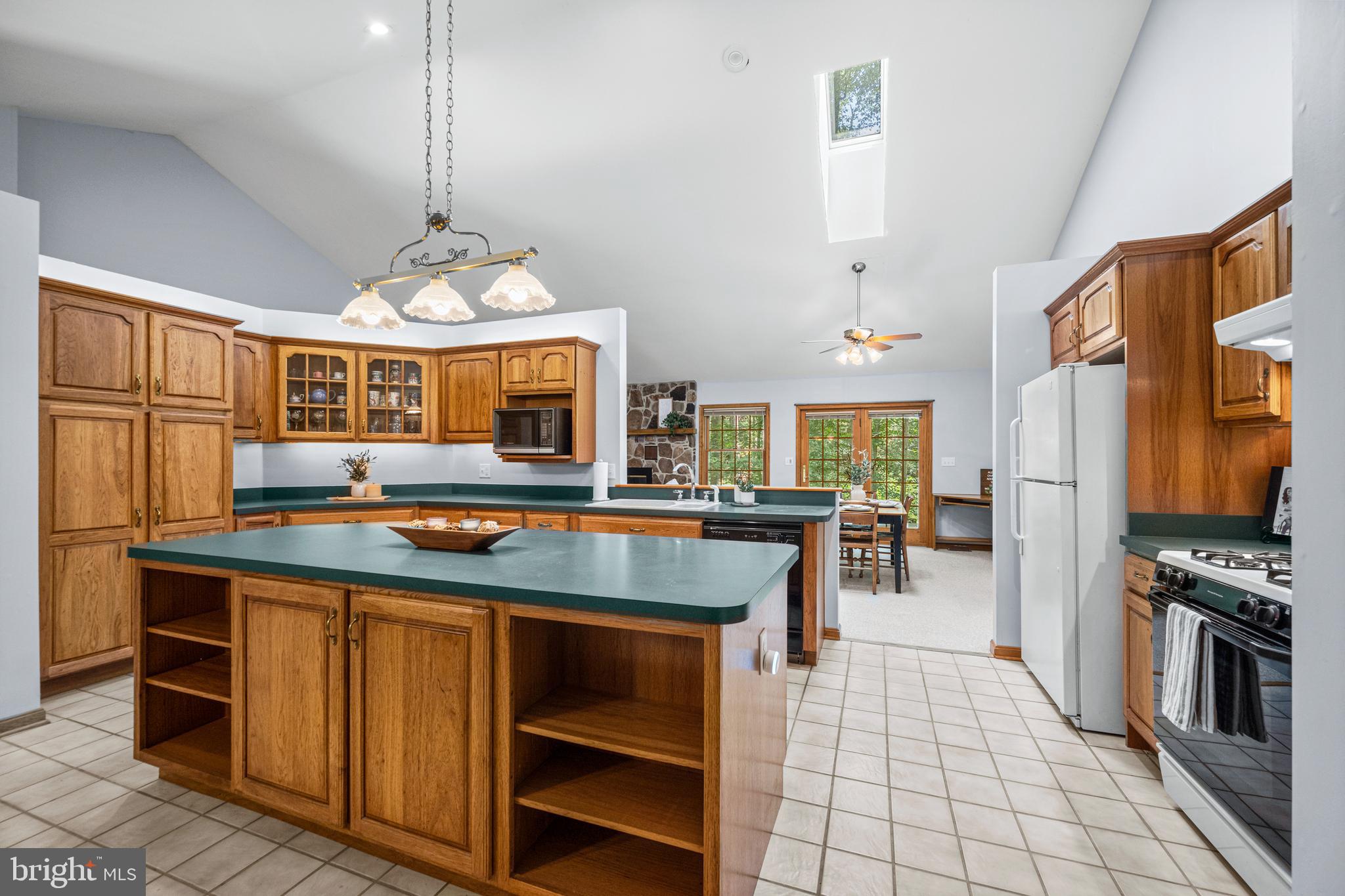 1160 Mt Hope Road Fairfield, PA 17320 - Photo 22 of 34 a kitchen with kitchen island granite countertop a stove and a view of dining room