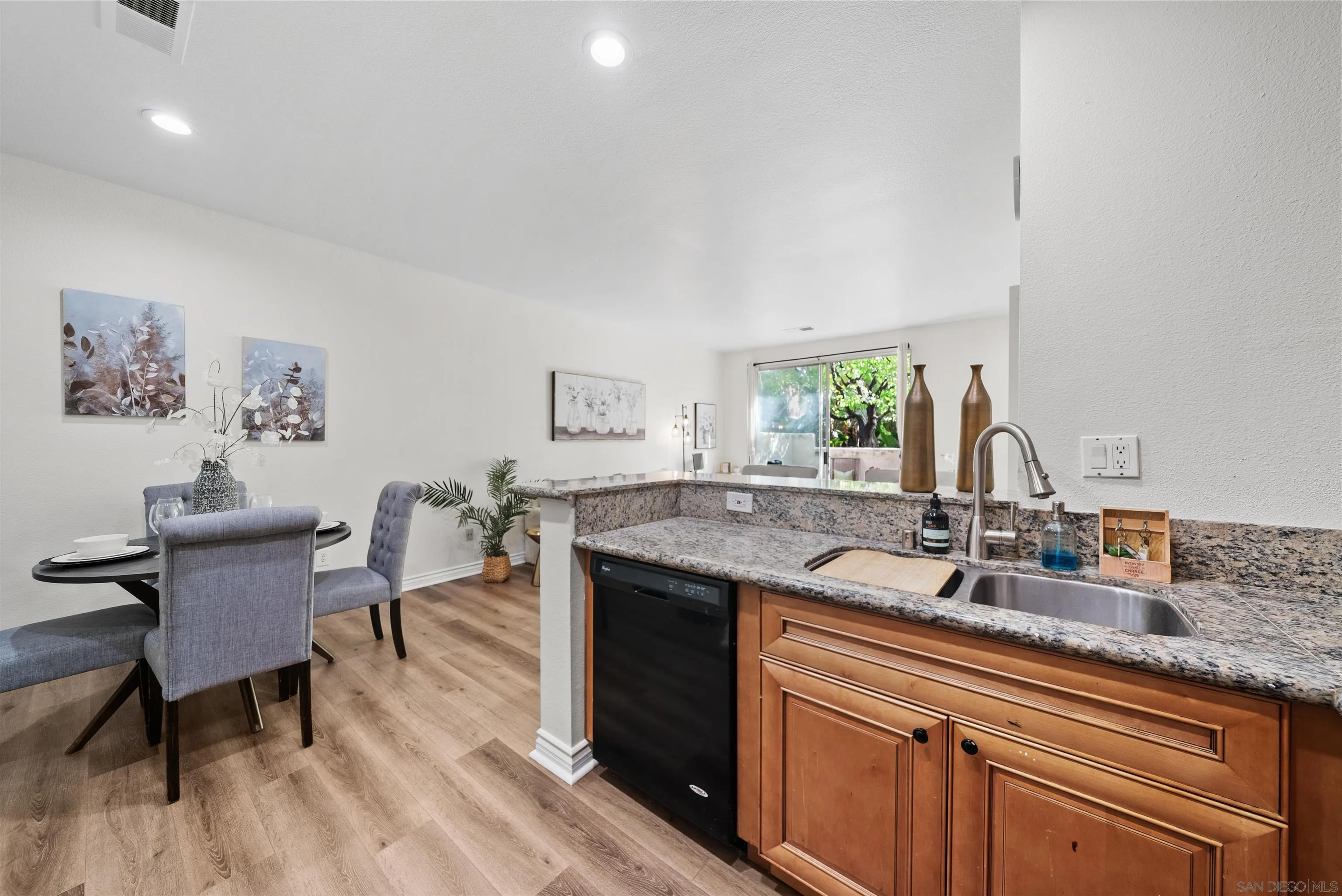 2291 Cabo Bahia Chula Vista, CA 91914 - Photo 11 of 45 a kitchen with a sink cabinets and wooden floor