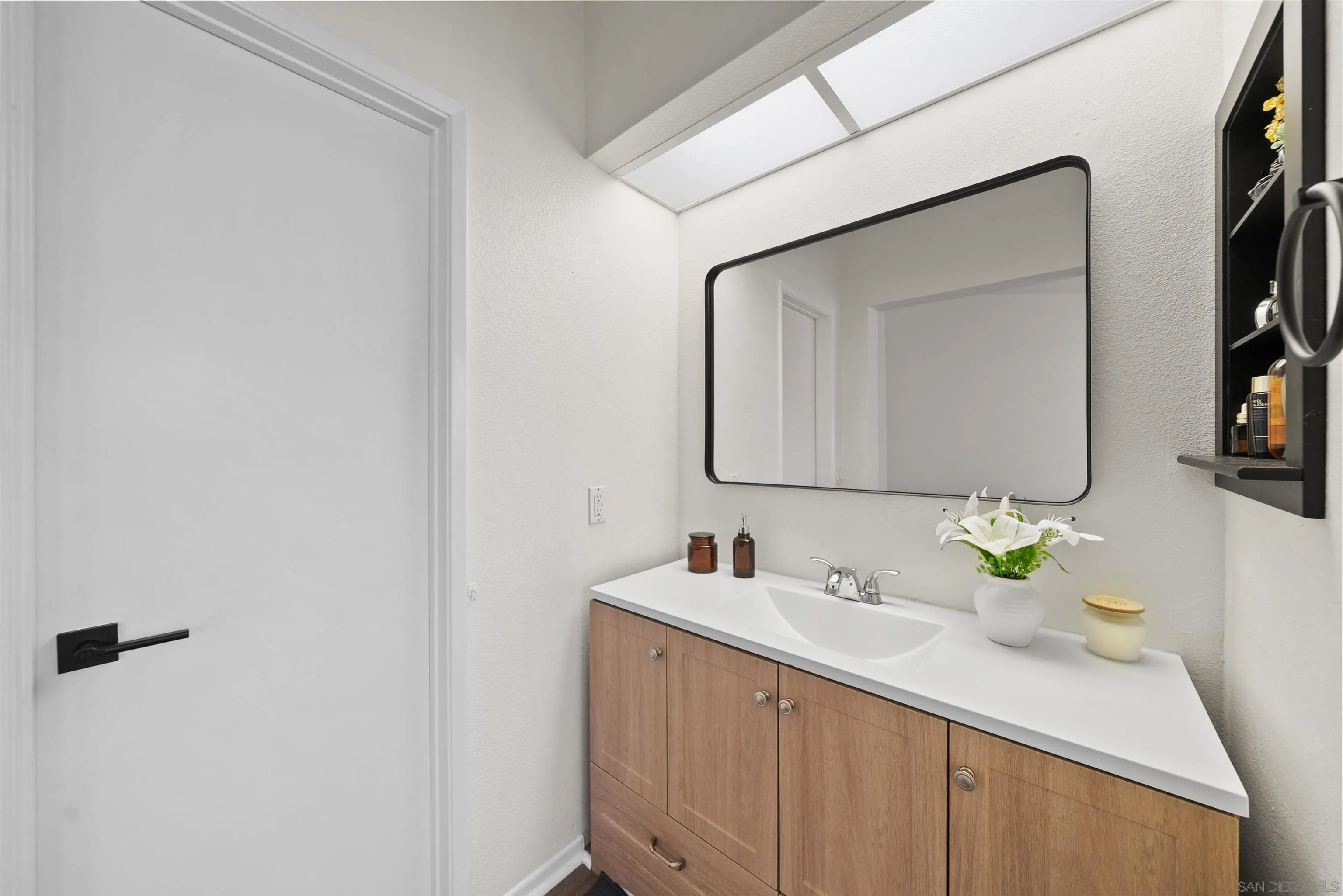 2291 Cabo Bahia Chula Vista, CA 91914 - Photo 24 of 45 a bathroom with a sink and a mirror